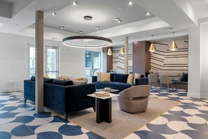 A modern living room with sofas, a coffee table, and pendant lights. - Sapphire Shores Lakeside Escape Pet Friendly (Rowlett)