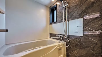 Combined shower/tub, hair dryer, slippers, towels