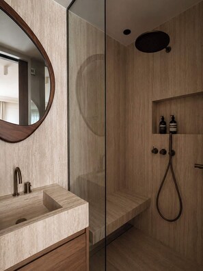 A modern bathroom with a glass shower enclosure, a wooden vanity with a sink, and a mirror. - Madame Luxury 3BR 6P with AC (Paris)