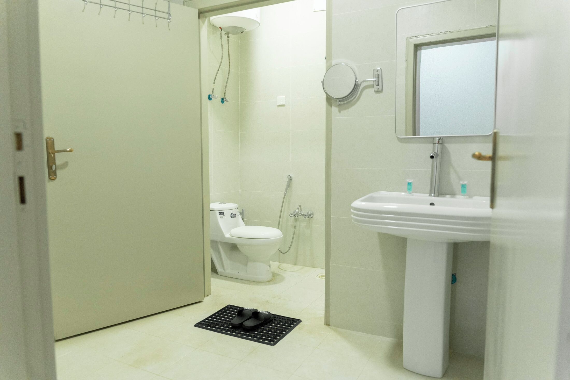A bathroom with a toilet, a sink, and a shower.