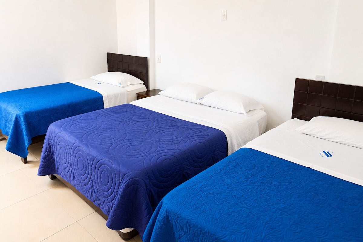 Standard Quadruple Room | Desk, laptop workspace, WiFi (free), bed sheets