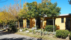A yellow building with a sign reading 'MARKET ALIMENTARI.' - 2-bed Tuscan Mobile Home With Garden (Bucine)