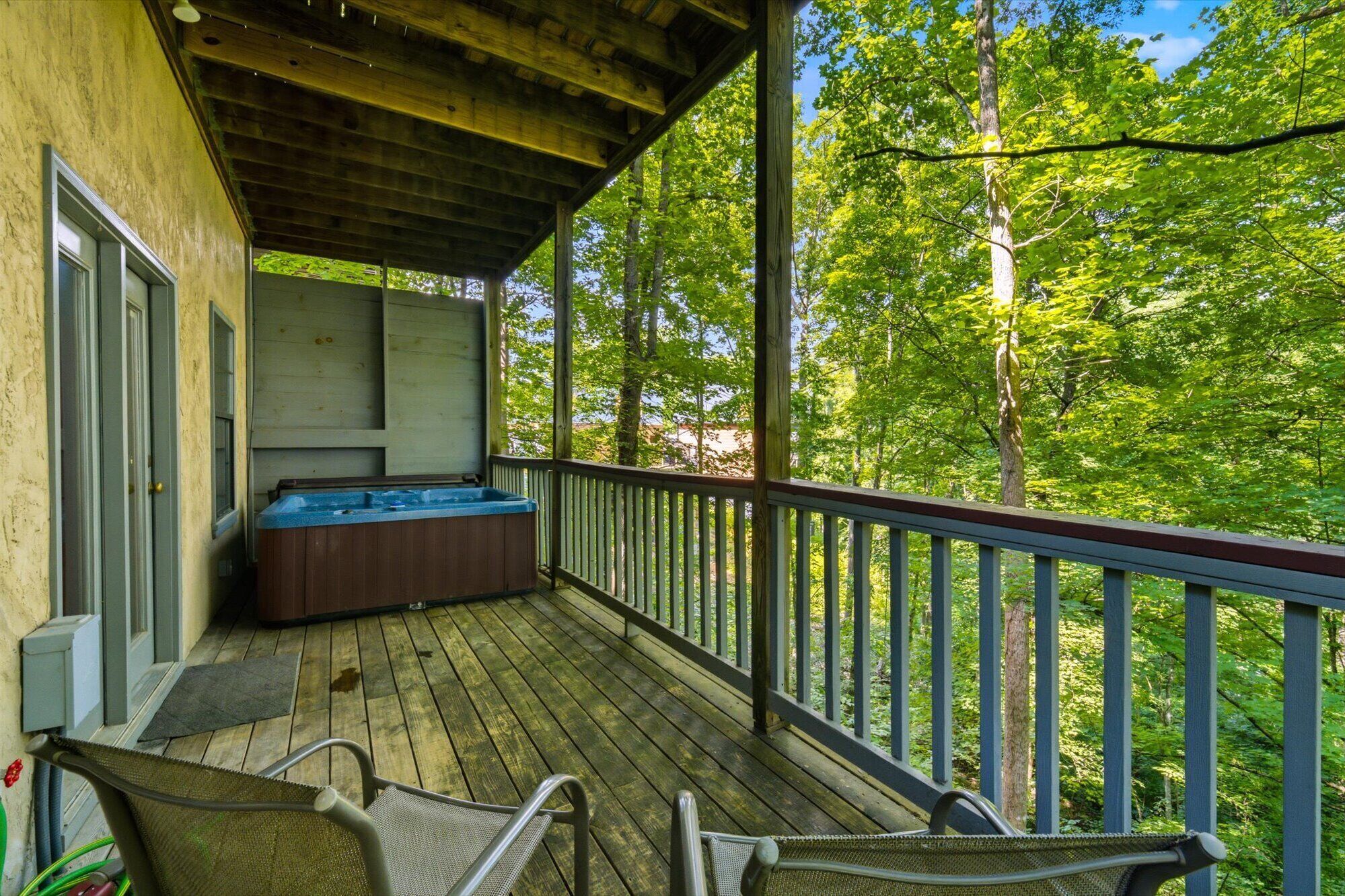 Unwind in your private hot tub while surrounded by lush treetops, then sink into a lounge chair and breathe in the peaceful forest views from your covered deck.