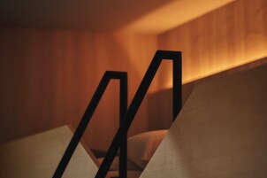 A close-up of a geometric, modern-designed object with a warm ambient light source in the background.