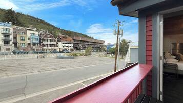 A hotel balcony with a view of a street and buildings.