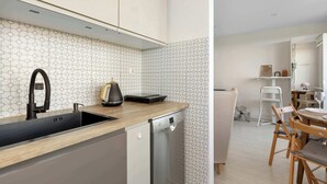 A modern kitchen with a dishwasher, a sink, and a coffee maker. - Sunny Studio with a Balcony | Gdańsk | Close to Nature (Gdańsk)