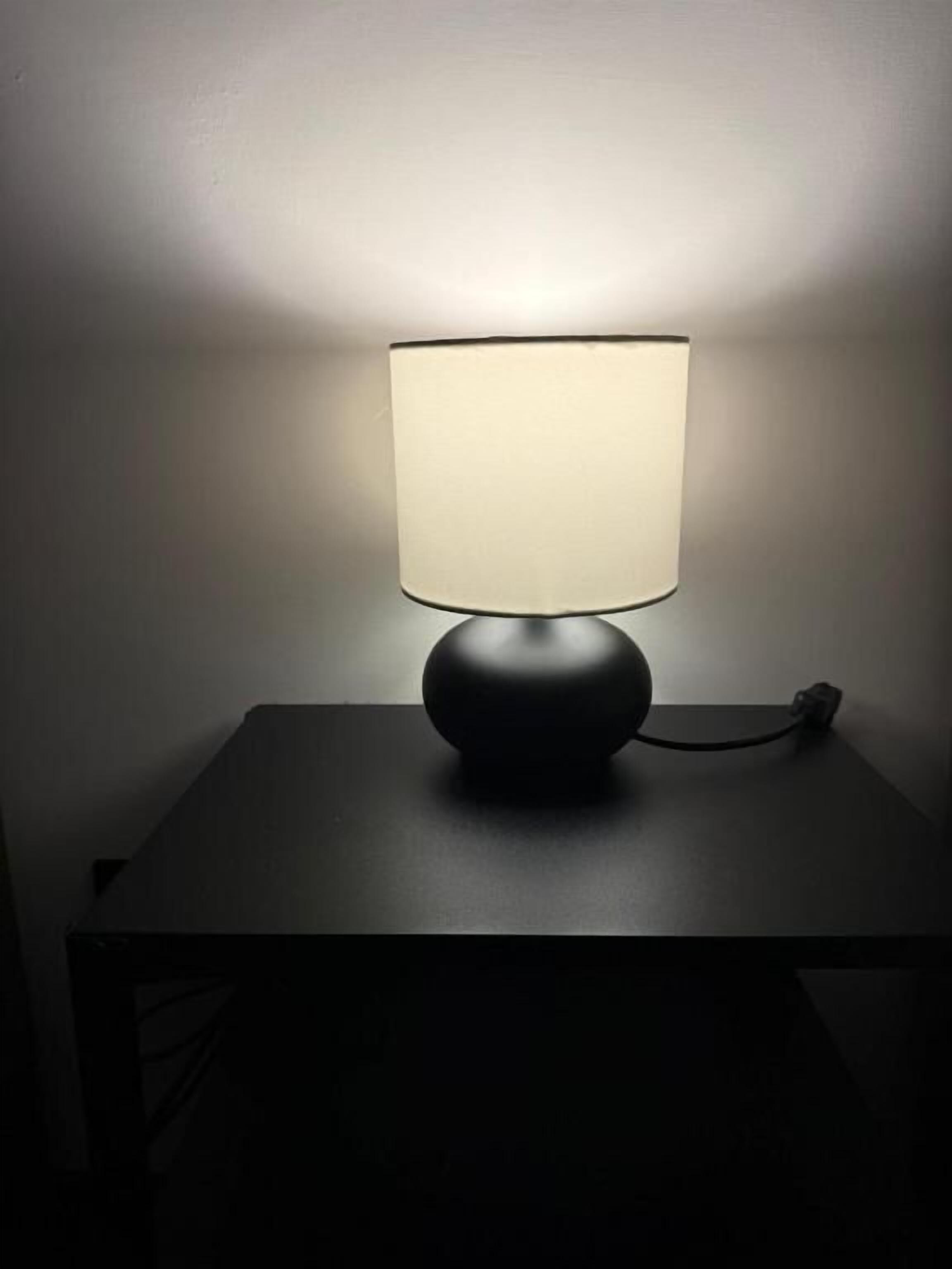 A table with a lamp on it.