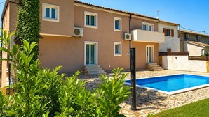 A two-story building with a swimming pool, air conditioning units, and a staircase leading to the upper floor. - Holiday Home with Private Pool, Istria (Up to 10 Guests, Pet Friendly) (Smoljanci)