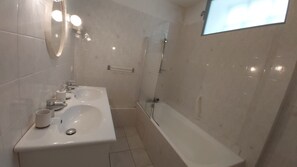 A bathroom with a sink, mirror, and shower. - Apartment in A Hotel 'Villa Des Fleurs Ch Hélène N°27' with Mountain View and Wi-Fi (La Bourboule)