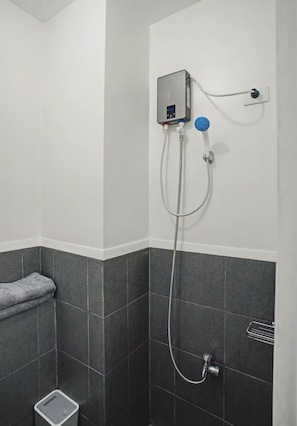 A shower with a control panel, a handheld showerhead, and a handheld shower attachment. - Studio at Urban Deca Towers Cubao (Quezon City)