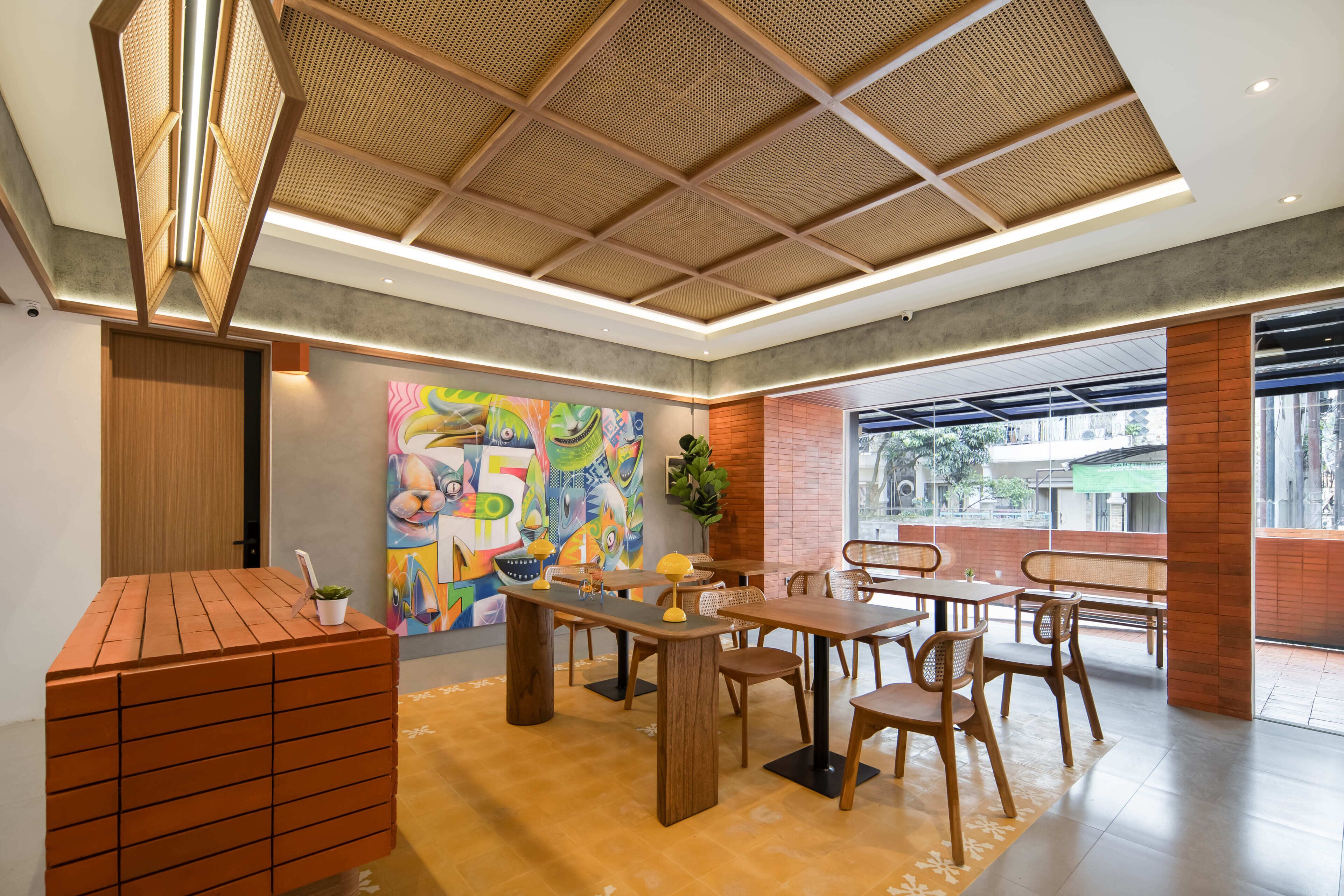 A modern interior with a wooden table and chairs, a colorful abstract painting, and a large window.