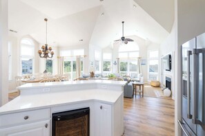 A spacious kitchen with a large island, a dining area with a view, and a ceiling fan. - Newly Renovated: Pool/Spa, GameRm, Community Perks (Corolla)
