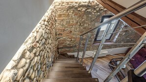 A wooden staircase with stone walls and metal railings. - Elegant Tuscan Home in Chianti Near Florence (Sant'Andrea in Percussina)