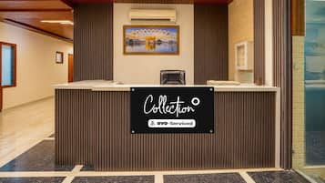 A reception desk with a sign indicating it is a self-service area.