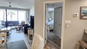 A hotel room with a bed, a TV, a desk, and a chair. - Pelican Pointe - Beautiful Beach Front Condo! 2nd Floor, 3 Bedroom (Orange Beach)
