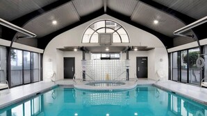 An indoor swimming pool with a high ceiling, large windows, and a central viewing area. - Pelican Pointe - Beautiful Beach Front Condo! 2nd Floor, 3 Bedroom (Orange Beach)
