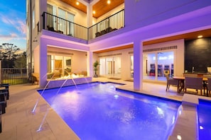 A modern multi-level house with a swimming pool, outdoor seating, and a bar area. - Huge Corner House 30A! Free Bikes/Walk to Beach! (Santa Rosa Beach)