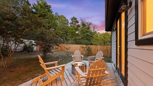 A wooden deck with Adirondack chairs and a fire pit. - Golf Cart/Bikes! Dune Allen/Walk to beach! (Santa Rosa Beach)