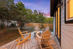 A wooden deck with Adirondack chairs and a fire pit. - Golf Cart/Bikes! Dune Allen/Walk to beach! (Santa Rosa Beach)