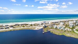 An aerial view of a coastal area with a marina, buildings, and a beach. - Golf Cart/Bikes! Dune Allen/Walk to beach! (Santa Rosa Beach)