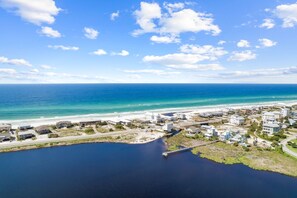 An aerial view of a coastal area with a marina, buildings, and a beach. - Golf Cart/Bikes! Dune Allen/Walk to beach! (Santa Rosa Beach)