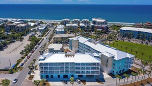 A coastal hotel with multiple buildings, a parking lot, and a view of the ocean. - Gulf Place 30A! Walk to Beach. (SANTA ROSA BEACH)