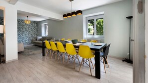 A dining area with a table, chairs, and a view of the outdoors.