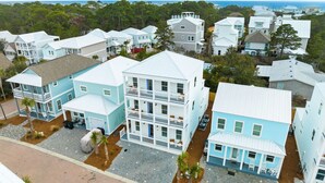 A coastal residential area with multi-story houses, paved streets, and a view of the ocean. - Dune Allen/30A! Walk to Beach/Coffee/Dinner! Bikes! (Santa Rosa Beach)