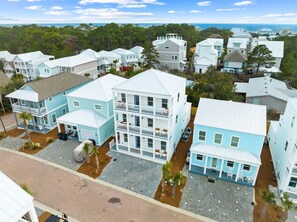 A coastal residential area with multi-story houses, paved streets, and a view of the ocean. - Dune Allen/30A! Walk to Beach/Coffee/Dinner! Bikes! (Santa Rosa Beach)