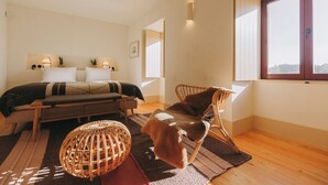 A bedroom with a bed, bedside tables, a chair, a window, and a view. - Casa Villae Relais & Châteaux - The most charming house in the Dão region (Silvã de Cima)
