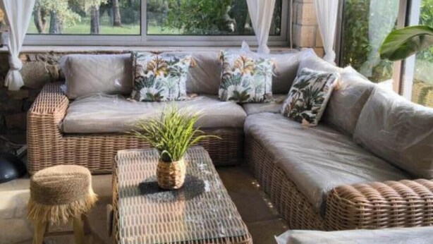A room with a large window, wicker furniture, and a plant on a table. - 130m2 ground floor villa with private pool on 4000m2 of land (Les Arcs)