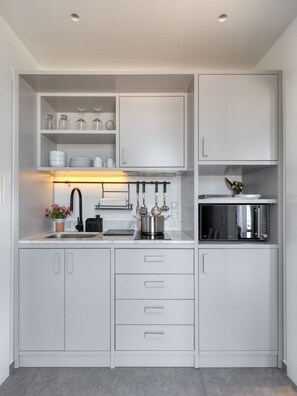 A modern kitchen with white cabinetry, a built-in microwave, and a pot on the countertop. - Beachfront Villa Ondyrelis, Divine Sea Views, Furnished Terrace, Hydra (Hydra)