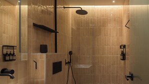 A modern bathroom with a bathtub, a shower, and a large mirror. - Two Bedroom Suite with Balcony, Spartacus Garden (Rethymno)