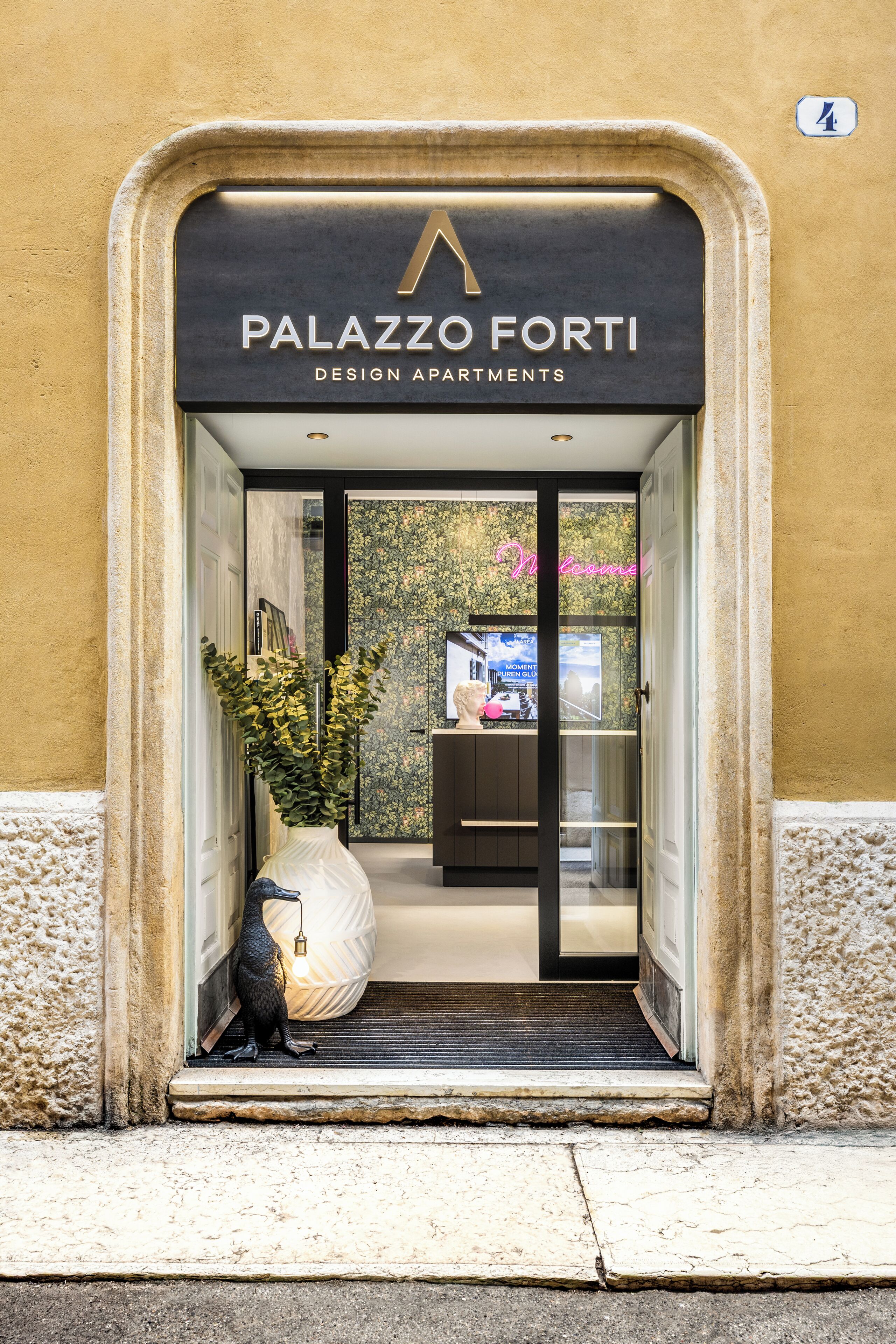 The entrance to Palazzo Forti Design Apartments with a clear view of the interior.