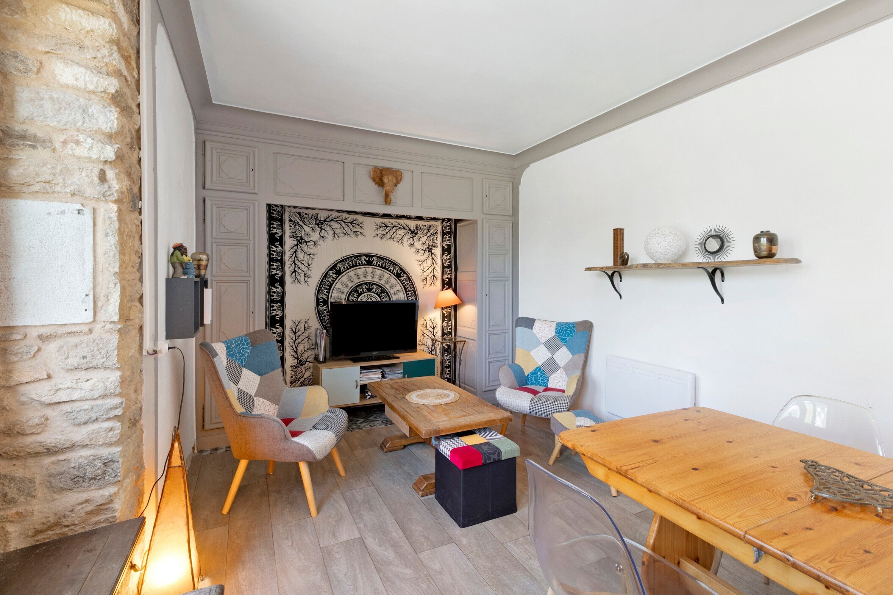 A cozy living room with a fireplace, a television, and a wooden coffee table.
