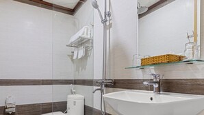 A modern bathroom with a shower, toilet, and sink. - Star Hotel (Da Nang)
