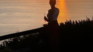 A sunset over a body of water with a silhouette of a person holding a drink. - Marèa - Capo Vaticano (Ricadi)