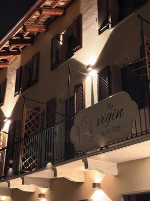 A building with a balcony, a sign reading 'by virgin country house,' and decorative lighting. - By Vigin Dalia – Comfort and Elegance for a Couples' Getaway (Magliano Alfieri)