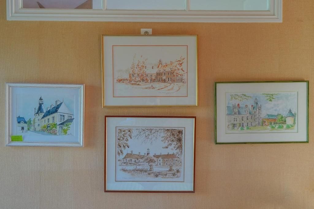 Four framed artworks on a wall.