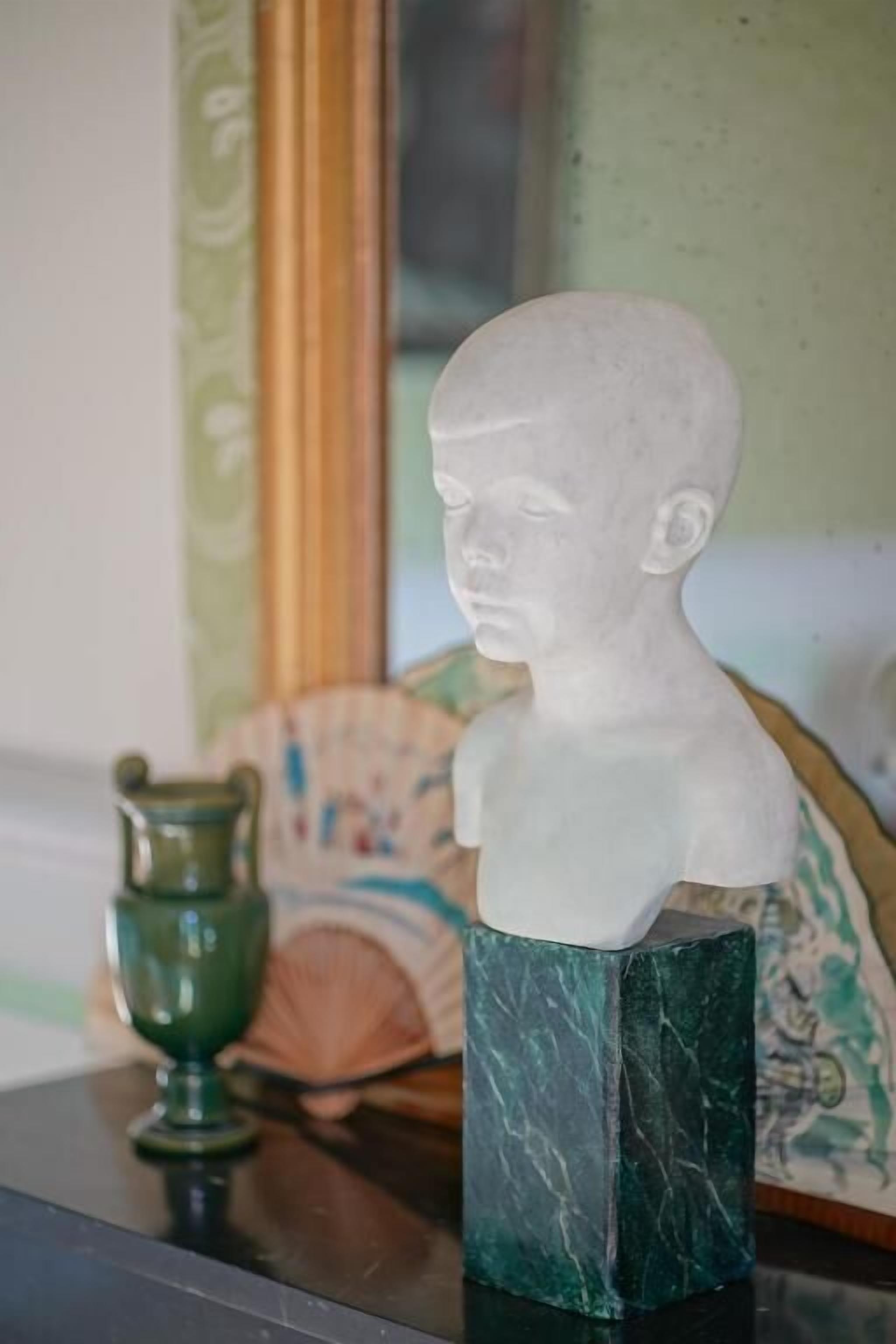 A bust sculpture on a marble pedestal.