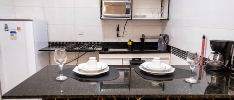 Fridge, microwave, coffee/tea maker, cookware/dishes/utensils