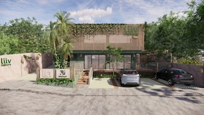 A modern building with a green roof, a carport, and a sign that reads 'liiv nature Pipa.' - Liiv Nature Pipa (Tibau do Sul)