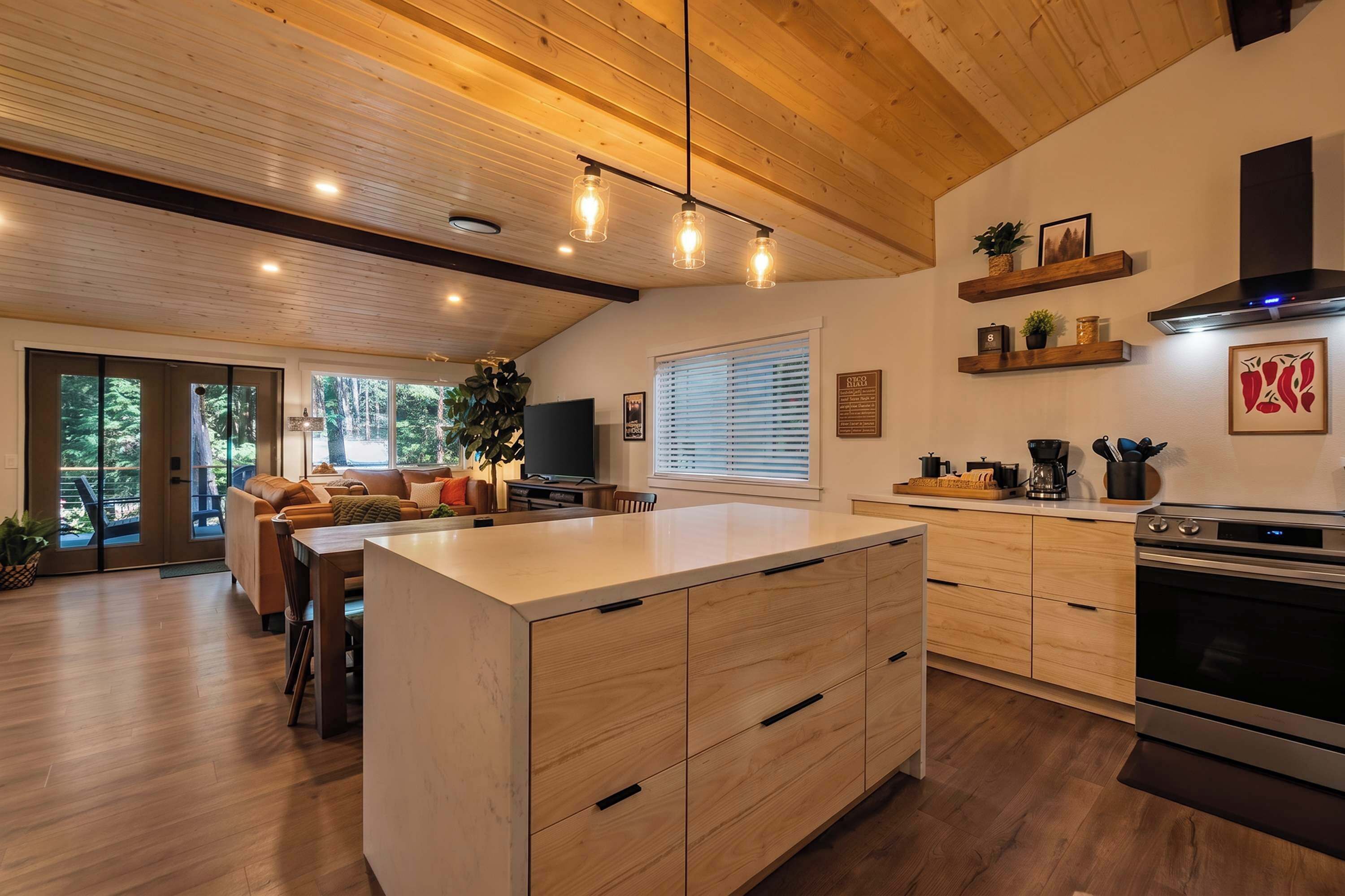 A modern kitchen with wooden cabinets, a central island, and a built-in oven.