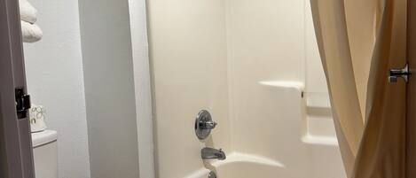 Bathtub, hair dryer, towels, soap
