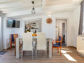 A modern kitchen with white cabinets, a built-in oven, and a fruit bowl on the counter. - Vacation home Tuli by Interhome (Lloret de Mar)