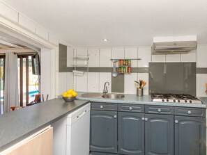 A modern kitchen with a dishwasher, stove, and a variety of utensils. - Vacation home Tuli by Interhome (Lloret de Mar)