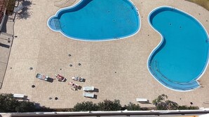 An aerial view of a swimming pool complex with multiple pools and sun loungers. - 'Achacay Beach' Holiday Apartment with Sea View, Pool and Wi-Fi (Los Cristianos)