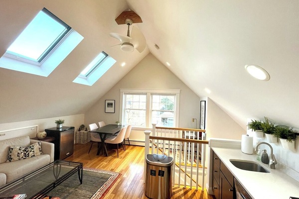 The spacious living area has high ceiling and is full of natural light.