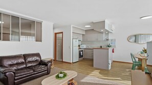 A modern apartment with a living room, a dining area, and a kitchen. - Yarrawonga Lakeside Apartment 48 (Mulwala)