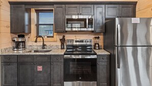 A compact kitchen with a stove, microwave, and refrigerator. - Gatlinburg 23 min + Hot Tub + Fire Pit #1 (Cosby)